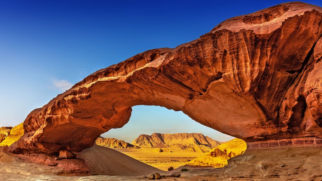 View through a rock arch in the desert of Wadi Rum, Jordan