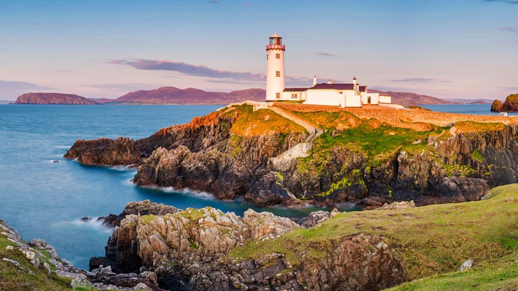 Fanad Head lighthouse and its cove at sunset, County Donegal, Ulster region, Ireland