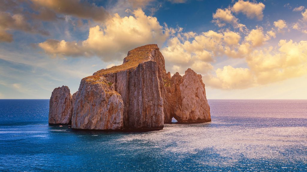 High cliffs of Mediterranean coast, "Pan di Zucchero" stack rock in Masua, Sardinia, Italy
