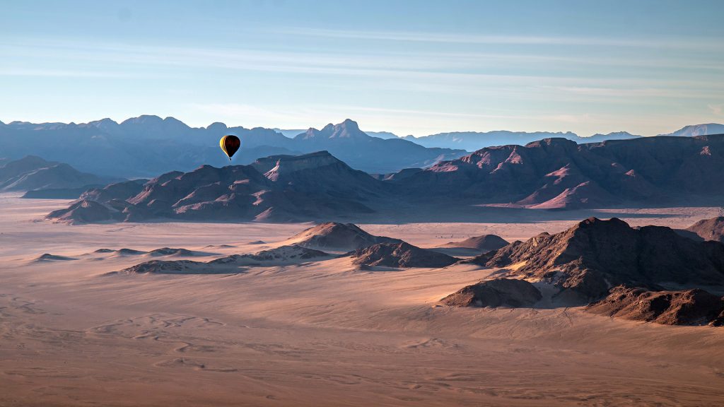 Aerial view with hot air balloon over rocky mountains, Namib-Naukluft National Park, Namibia