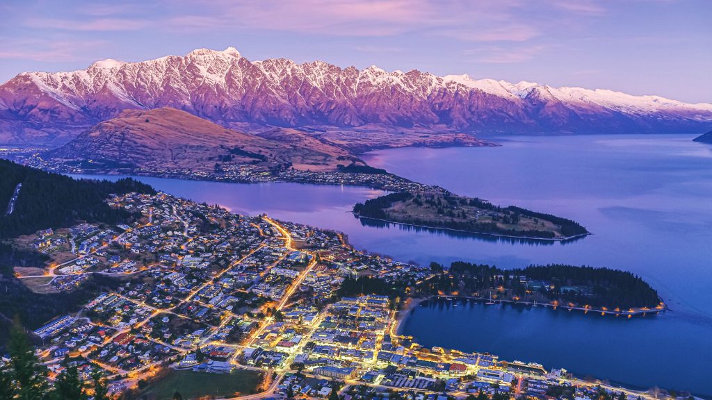 Aerial view of Queenstown at dusk with Lake Wakatipu and The Remarkables, New Zealand