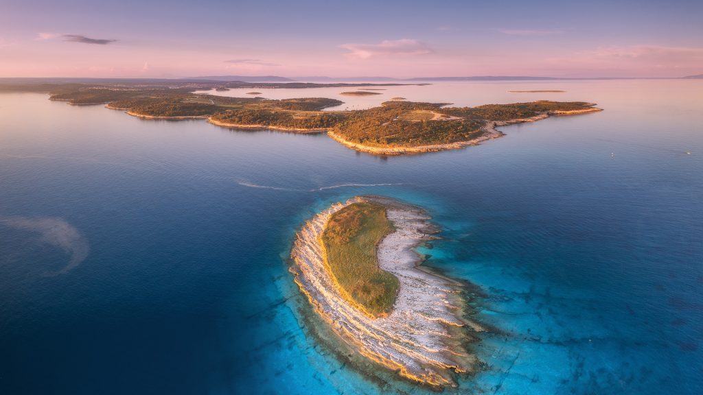 Aerial view of small island at sunset in summer, Kamenjak cape, Istria, Adriatic sea, Croatia