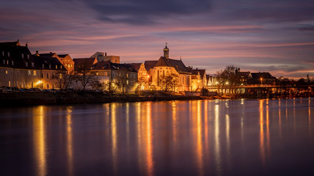 View from the Danube on the Regensburg Cathedral and Stone Bridge in the evening, Germany