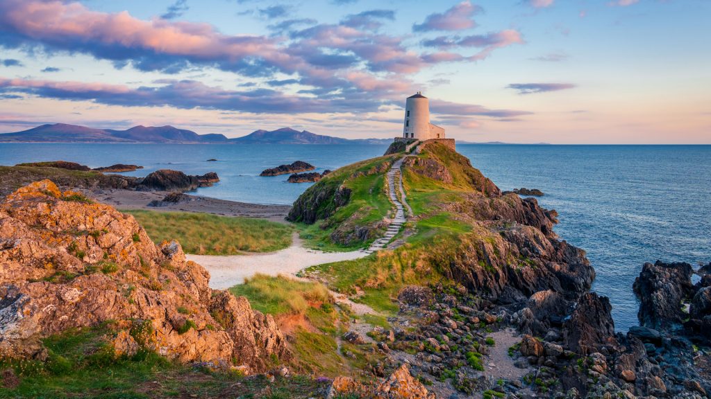 Tŵr Mawr Lighthouse at sunset on Ynys Llanddwyn island on Anglesey, North Wales, UK
