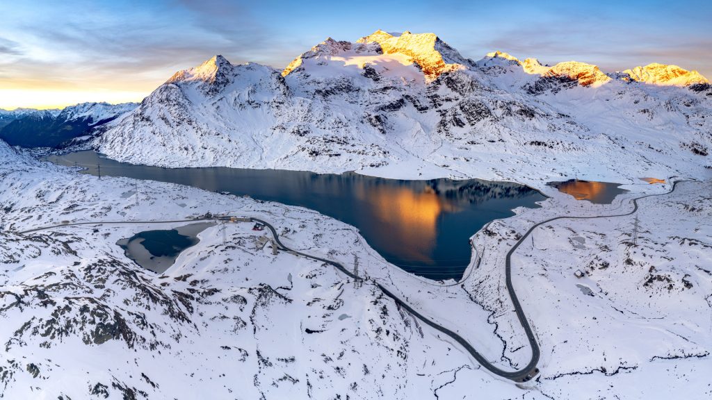 Winter sunrise over Lago Bianco and mountains, Bernina pass, Graubunden, Engadin, Switzerland
