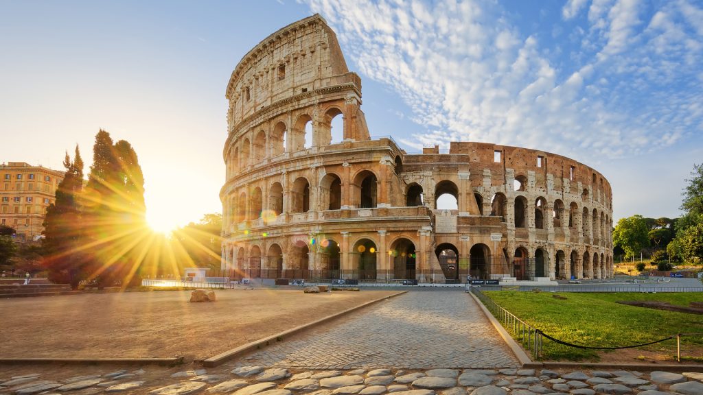Panoramic view of Colosseum in Rome and morning sun, Italy