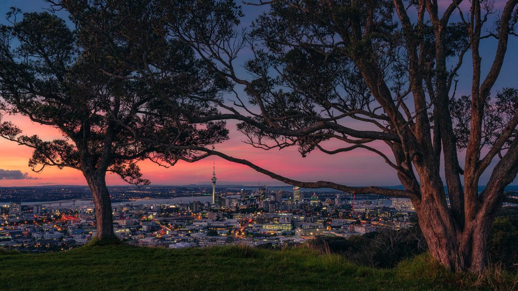 View from Mount Eden volcano to the Auckland skyline at sunset, New Zealand North Island
