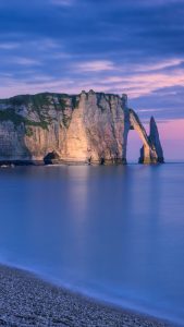 The chalk cliffs of Etretat during blue hour, Normandy, France ...