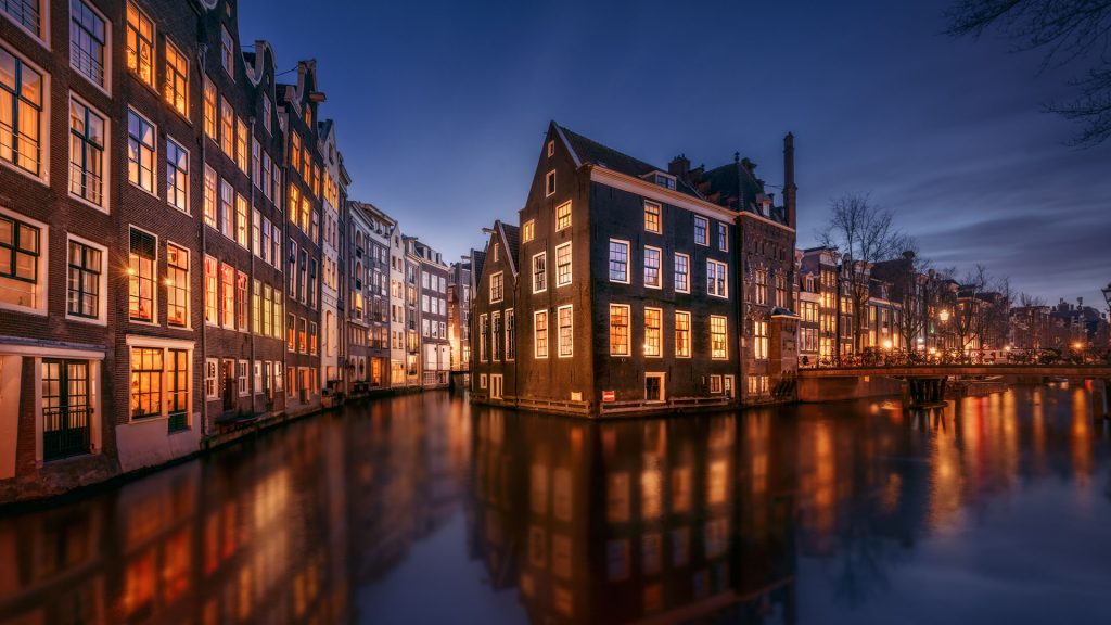 Amsterdam tranquil canal scene with canal houses by night, Netherlands