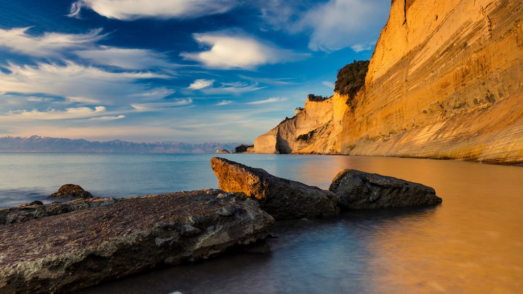Cliff of Loggas Beach on the west side of Corfu island in Ionian Sea at summer sunset, Greece