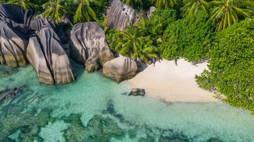 Drone view of Anse Source D'Argent beach in summer, La Digue Island, Seychelles