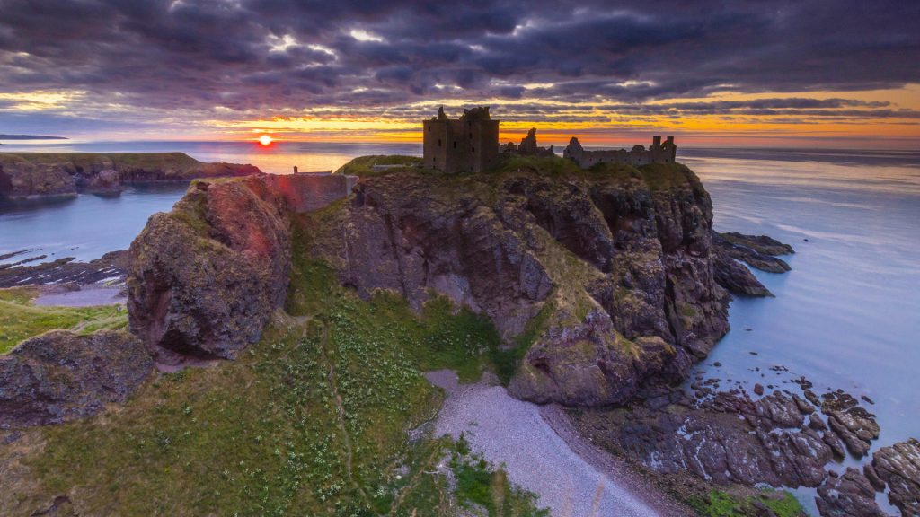 Sunrise on Dunnottar castle along the coastline, Stonehaven, Aberdeenshire, Scotland, UK