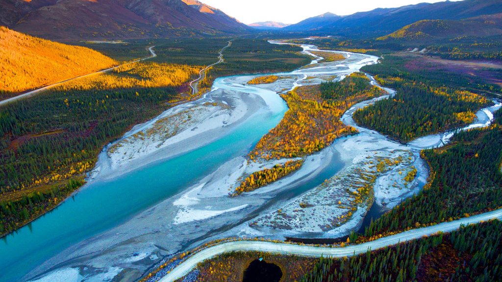 Autumn landscape with lake and Dalton Highway in Alaska, USA