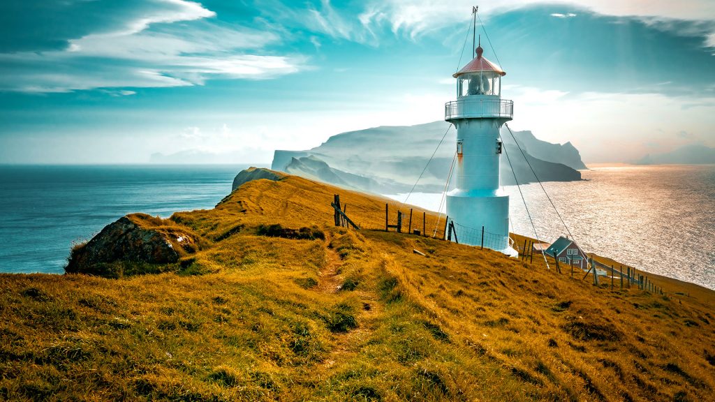 Lighthouse on a cliff at Mykines Island, Faroe Islands, Denmark