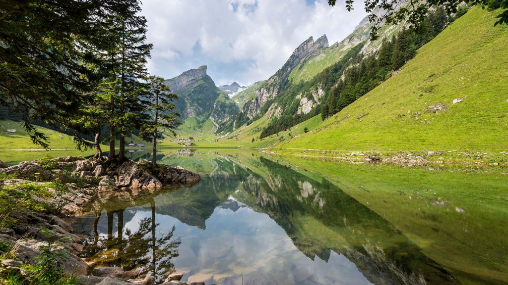 Clouds over mountain range with reflection in lake, Canton of Appenzell, Switzerland
