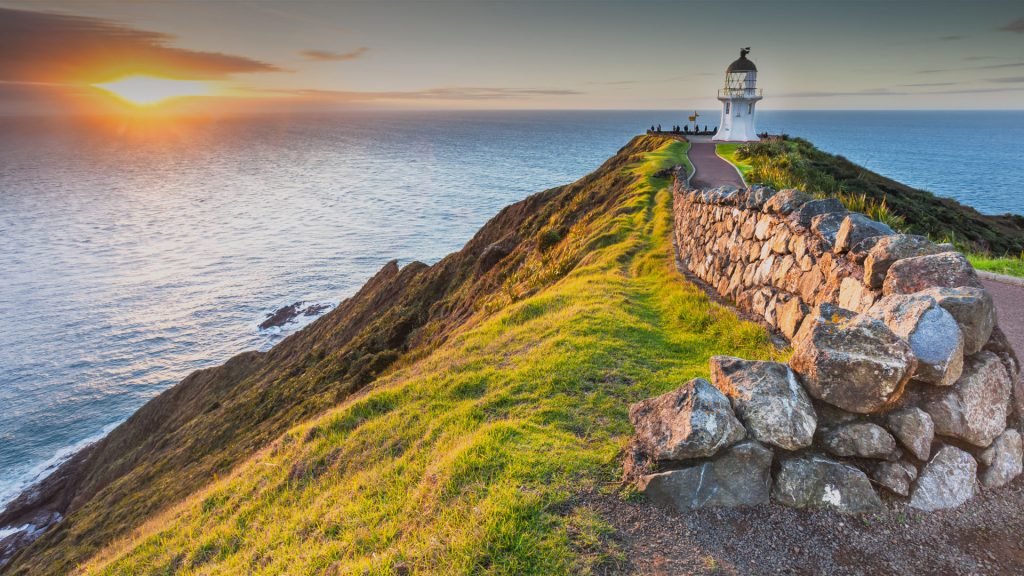 Walking path to Cape Reinga lighthouse at summer sunset, North Island of New Zealand