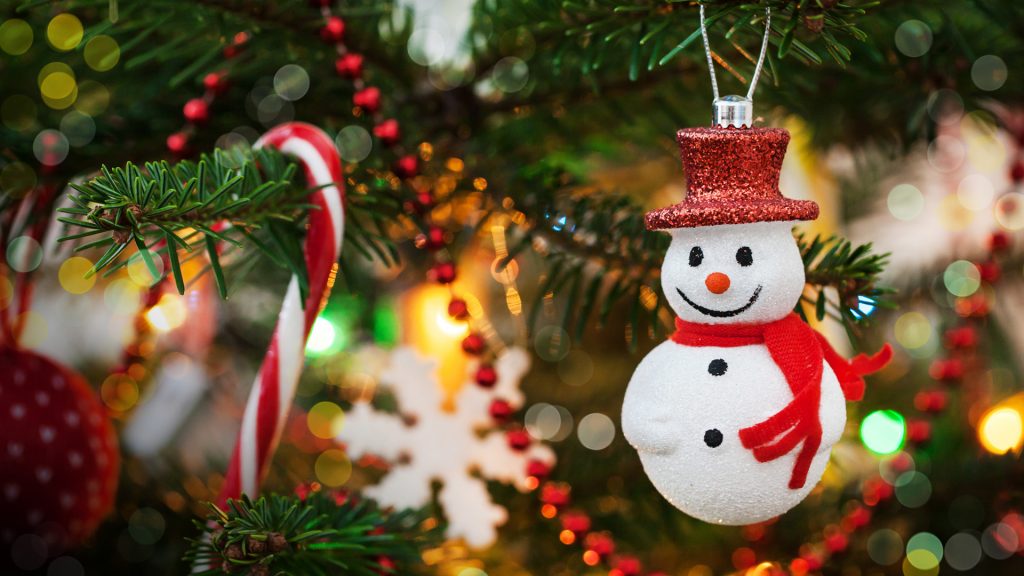 Christmas decoration snowman on xmas tree and garland background