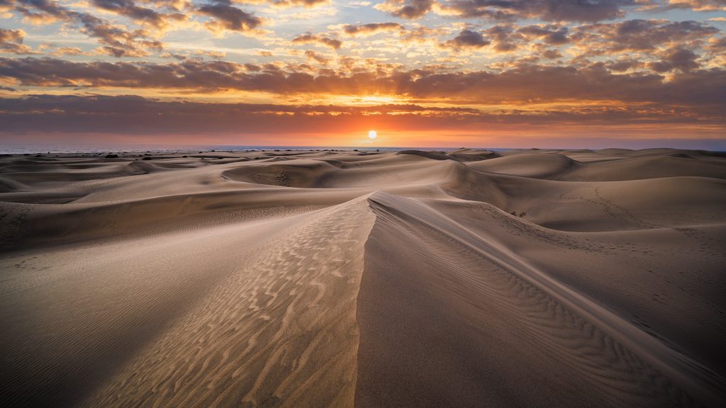Scenic sunset over giant sand dunes, Maspalomas, Grand Canary, Spain