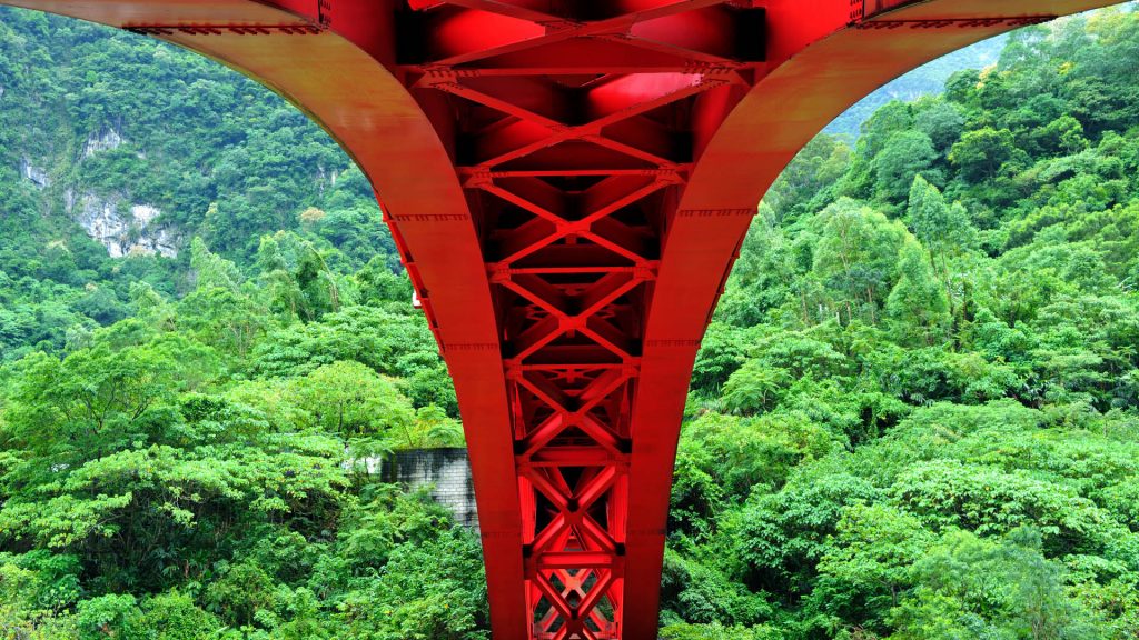 Looking at the red arch bridge across the forest, Taroko Gorge in Hualien, Taiwan