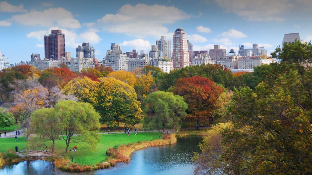 New York City Manhattan Central Park panorama in autumn, lake with skyscrapers and trees, USA