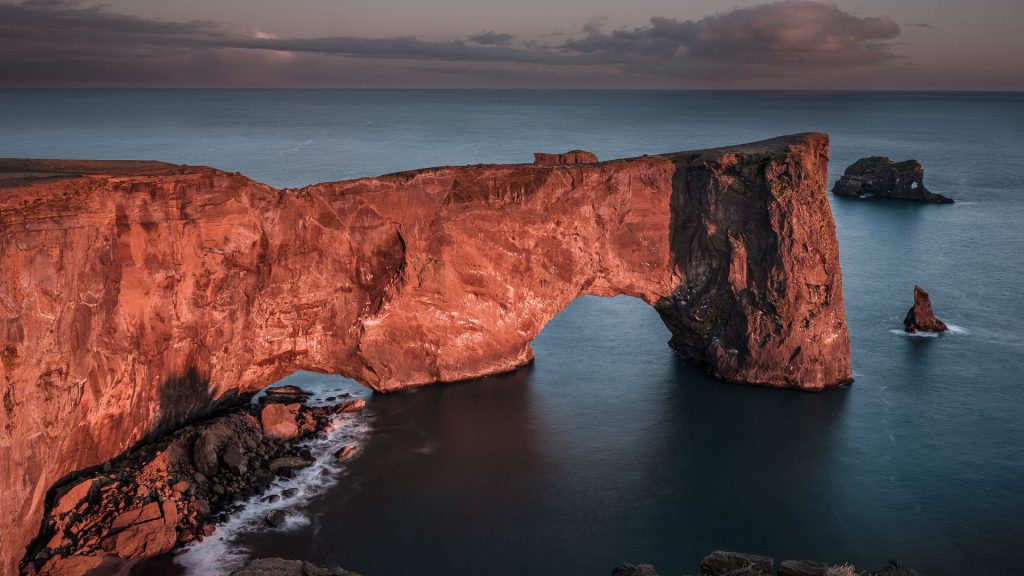 Dyrhólaey Arch rock formation at sunset not far from the village of Vik in Iceland