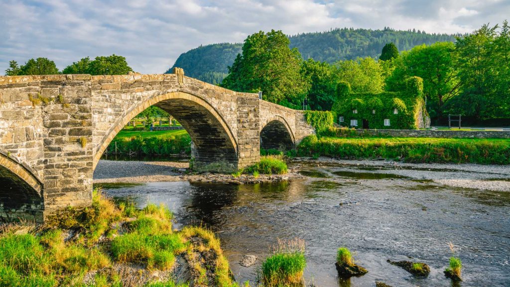 Stone bridge over the River Conwy and old cottage, Llanrwst, Caernarfon, North Wales, UK