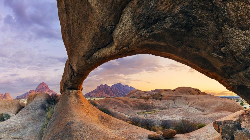 Sunrise at Archway at Spitzkoppe, Pontok Mountains in the background, Namibia