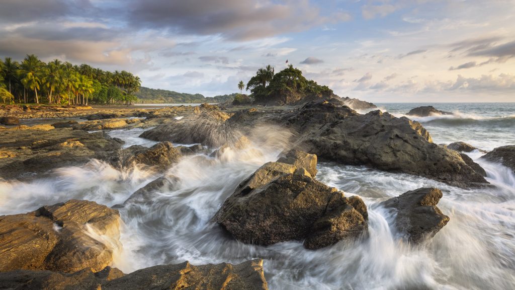 Waves crashing on the rocks of Rocas de Amancio on Dominicalito Beach, Puntarenas, Costa Rica