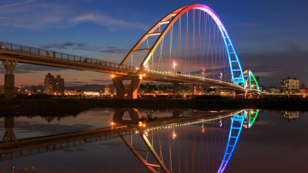 Night view of pedestrian Crescent Bridge over Tamsui River in New Taipei City, Taiwan