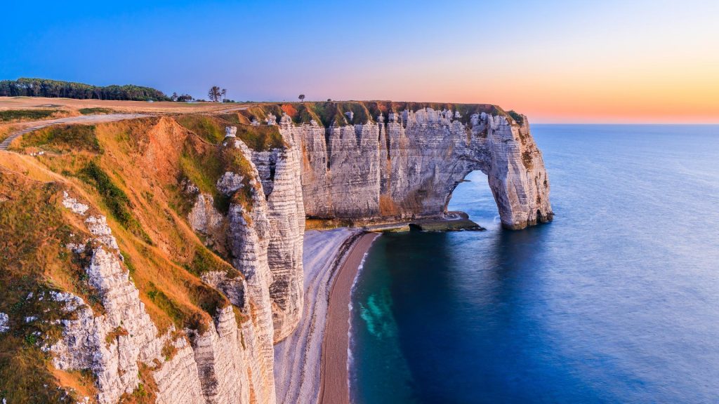 Etretat village cliffs with the Manneporte arch and the Valaine beach, Normandy, France