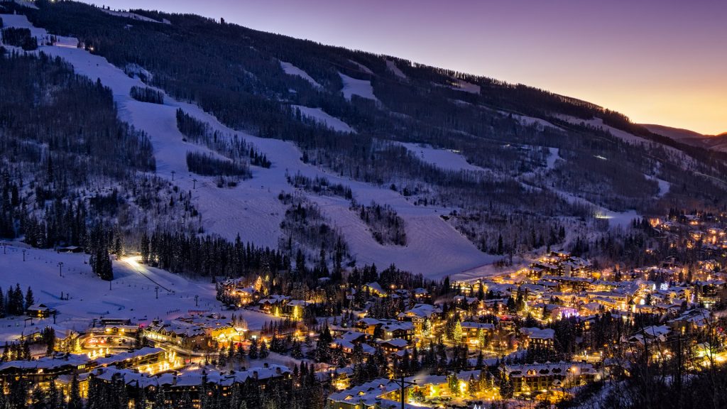 View of ski slopes and village in Vail at winter dusk, Colorado, USA