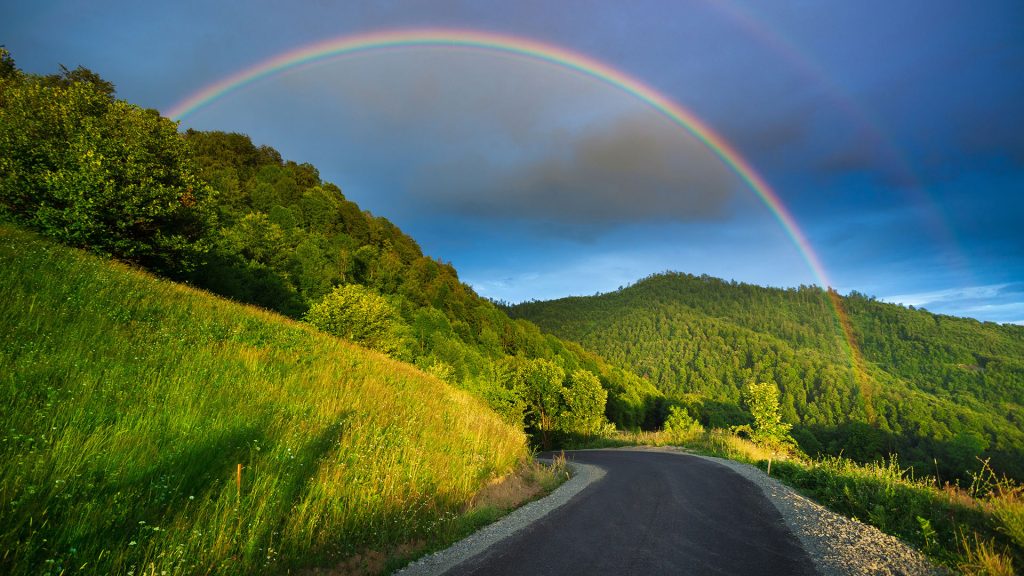Scenic rainbow landscape on the hills in rural peaceful area, Romania