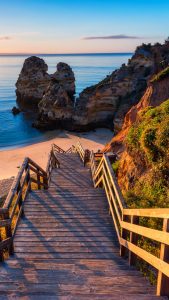 Wooden footbridge to Camilo Beach (Praia do Camilo) at sunrise, Lagos ...