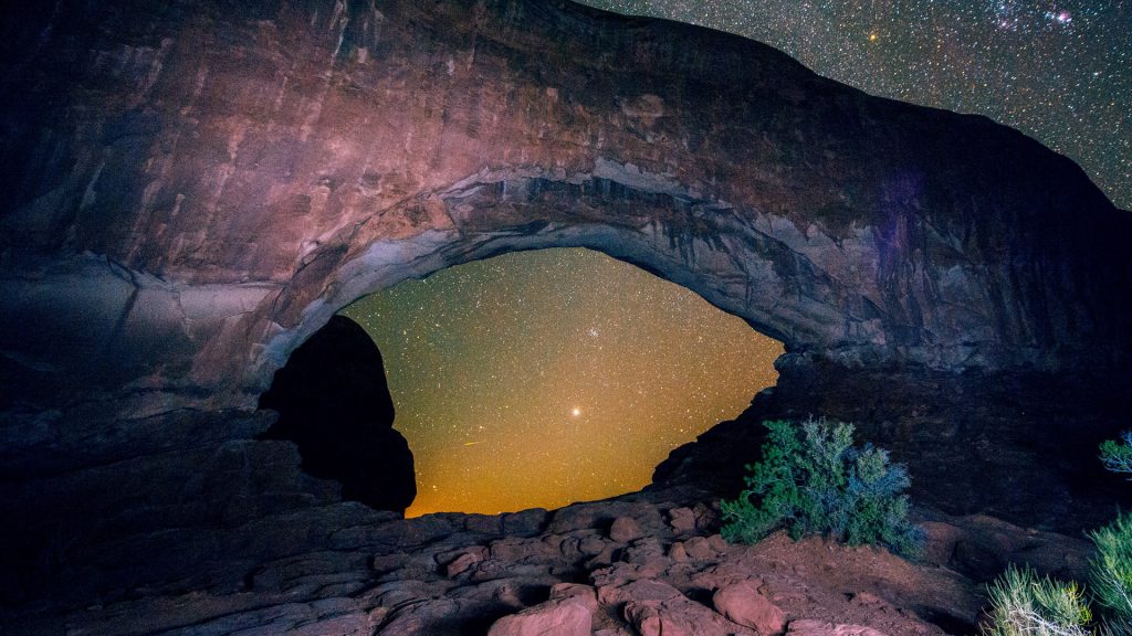 Arched rock formation and starry night sky, Arches National Park, Moab, Utah, USA