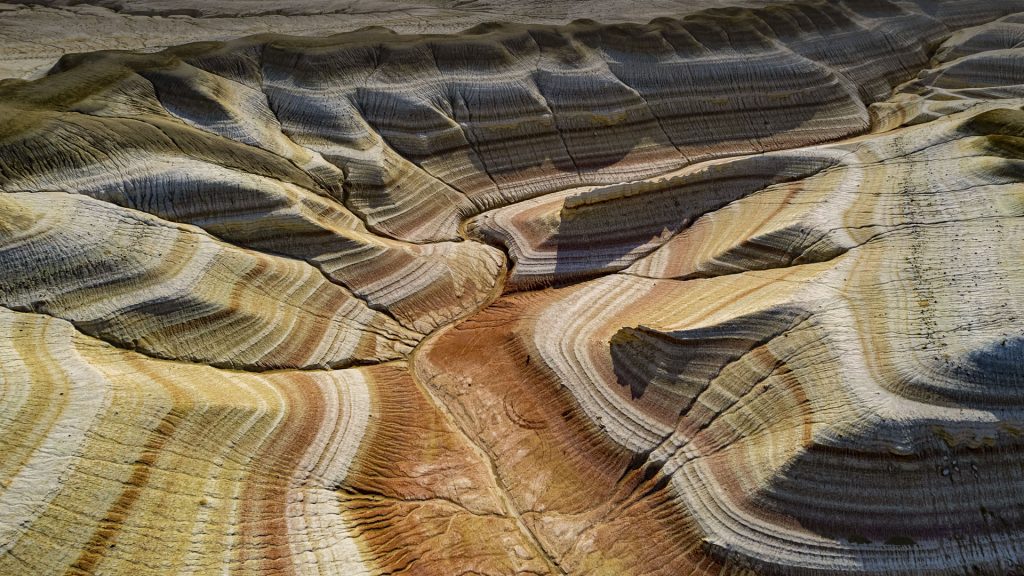 Aerial view of multicoloured layers of sandstone, Kyzylkup, Mangystau, Kazakhstan