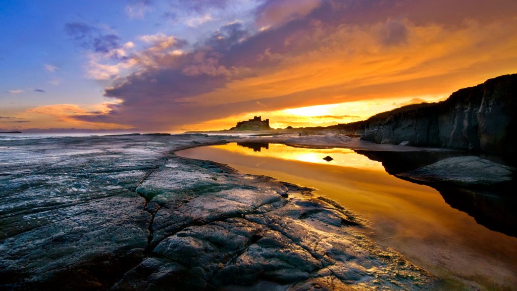 Sunrise over the beach and Bamburgh Castle on the Northumberland coast, England, UK