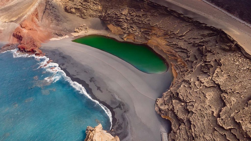 Aerial view of volcanic crater with a green lake, El Golfo, Lanzarote, Canary islands, Spain