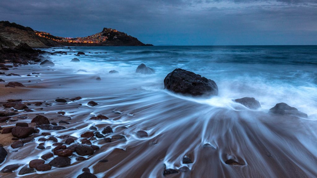 The Spiaggia Lu Poltu di la Rena overlooking Castelsardo at dawn, Sassari, Sardinia, Italy