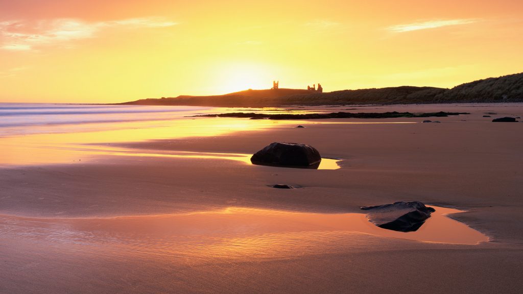 View along Embleton Bay at sunrise, near Alnwick, Northumberland, England, UK