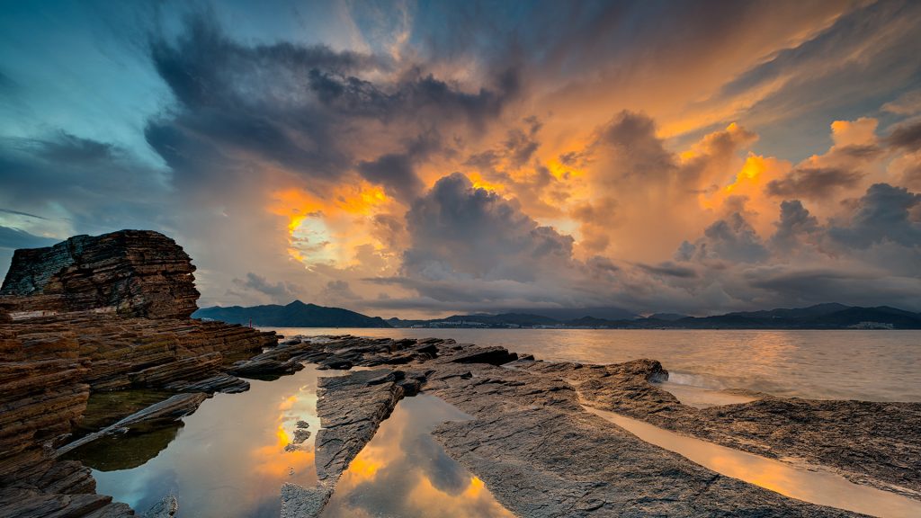 Beautiful shot of Tung Ping Chau under the yellow and dark blue sky at sunset, Hong Kong SAR