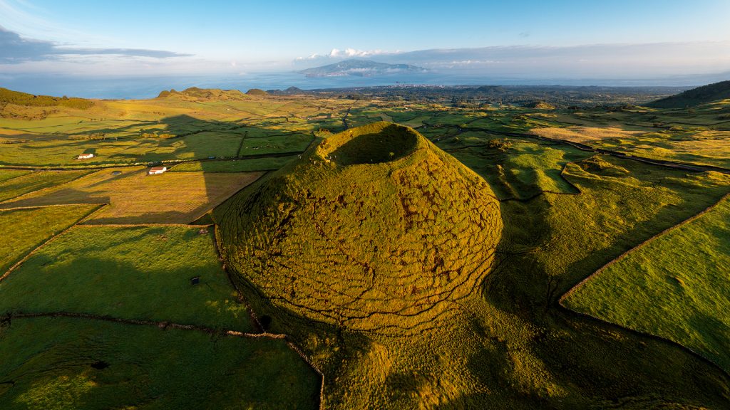 Aerial view of small volcano and coastline, Pico, Azores, Portugal