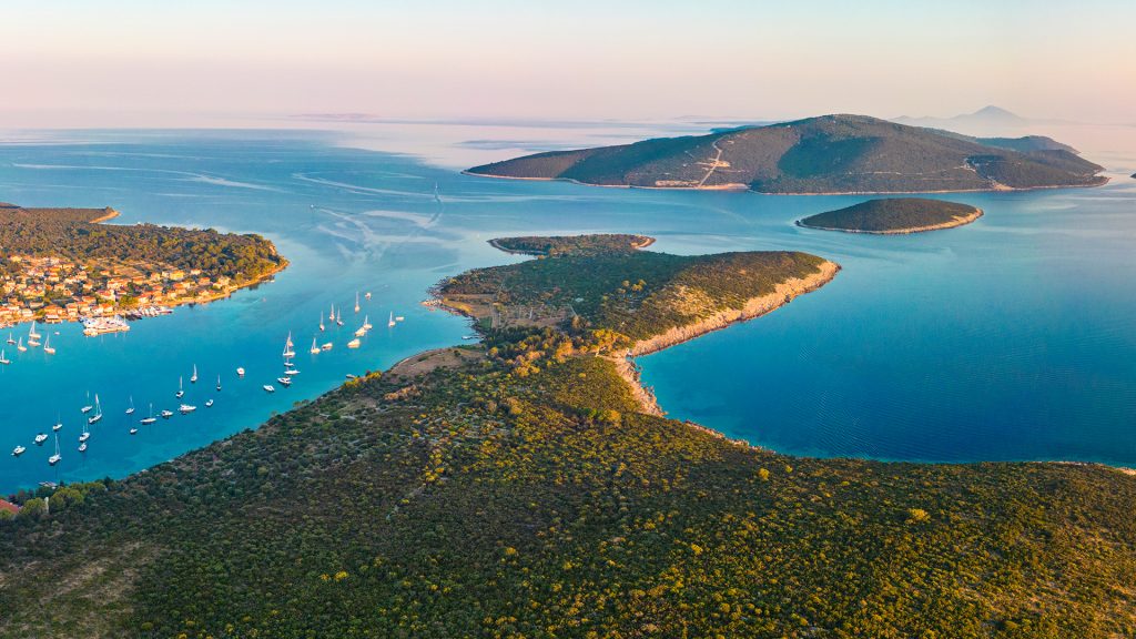 Boats sailing between two islands at sunset,Lošinj island, Kvarner Gulf, Croatia