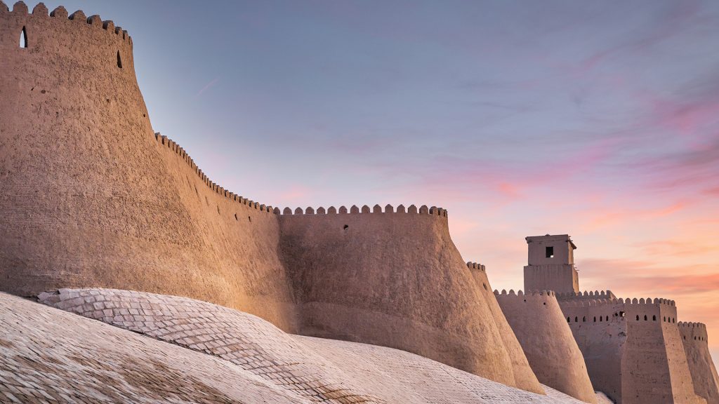 Historic Khiva City walls of old town under colorful sunset twilight, Khorazm, Uzbekistan