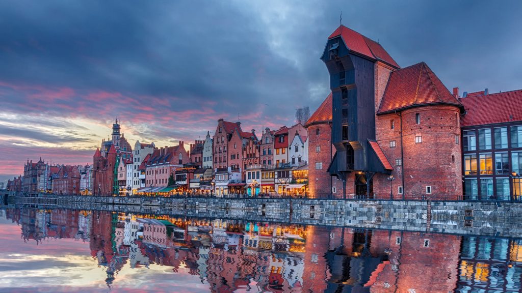 View on Zuraw port crane and medieval facades at sunset, Gdansk, Poland