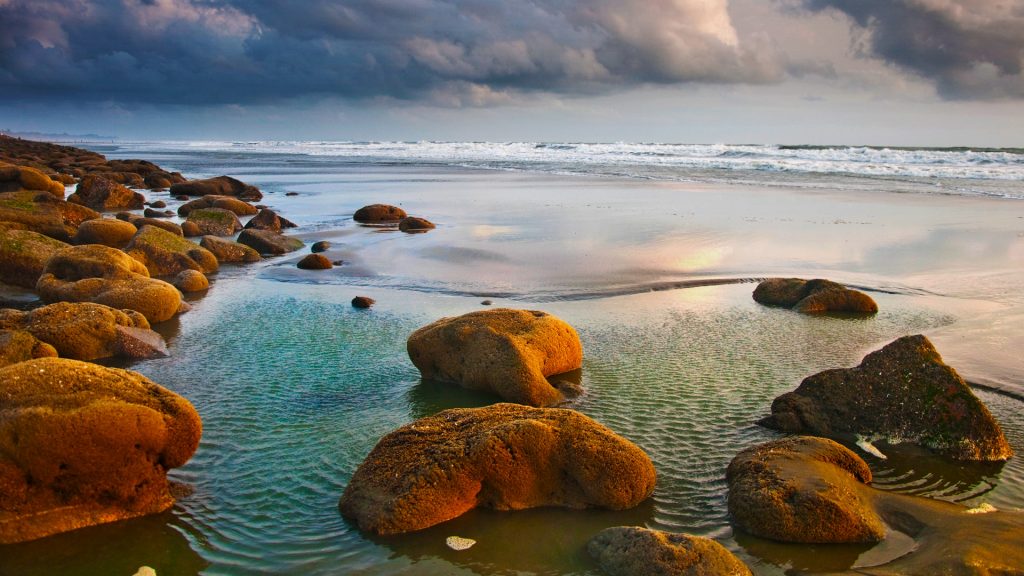 Rocks on beach under cloudy sky, Coxs Bazar, Chittagong Division, Bangladesh
