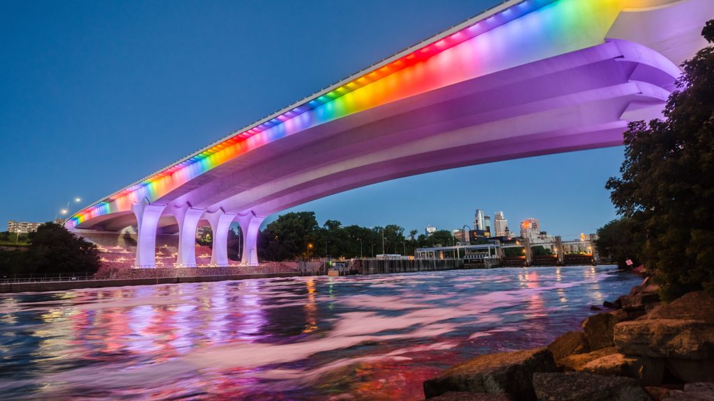 I-35W St. Anthony Falls Bridge lit in rainbow light, Minneapolis, Minnesota, USA