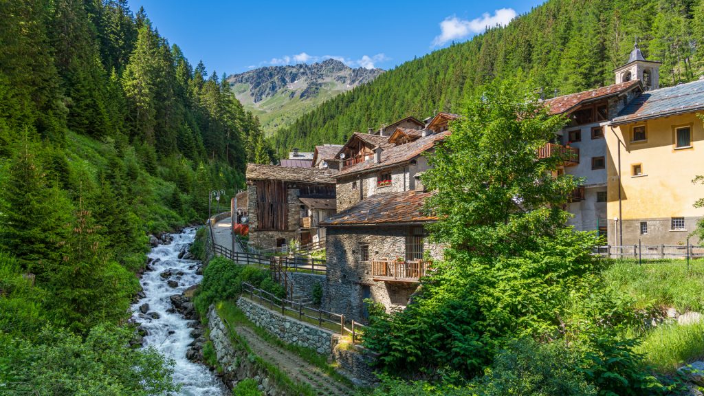 Idyllic sight of Saint-Rhémy-en-Bosses village at Artanavaz River, Aosta Valley, Italy