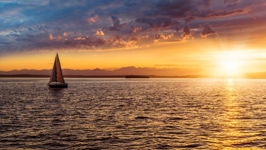 Sailboat in Elliott Bay at sunset, Seattle, Puget Sound, Washington State, USA