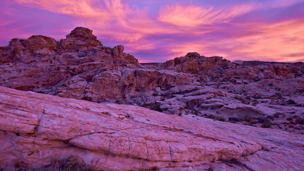 Vibrant orange clouds over red and white sandstone at sunset, Gold Butte, Nevada, USA