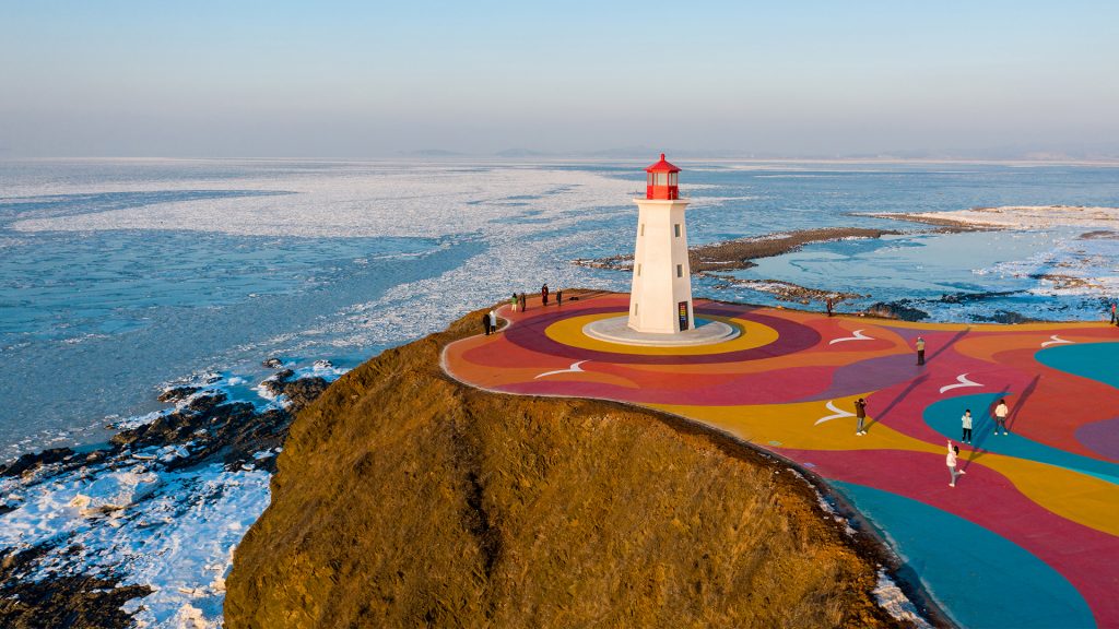 Lighthouse over the cliff by the sea, Boxia Bay Park, Dalian, Liaoning, China